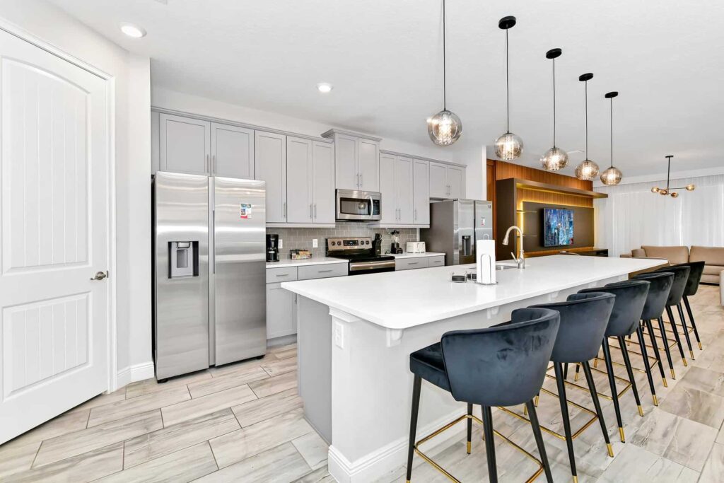 Fully equipped resort home kitchen with large island sink and barstool seats