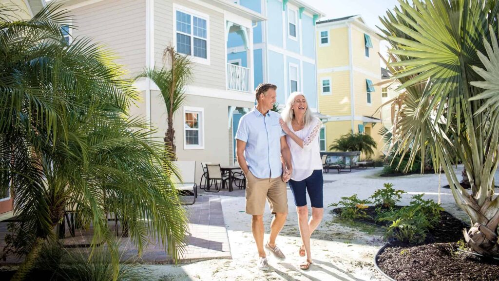 Happy couple walking together outside a Margaritaville Resort Orlando cottage